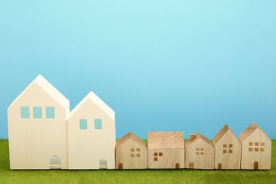 Houses in row of buildings against clear blue sky