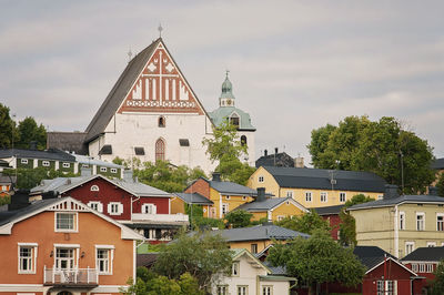 View of buildings and trees against sky