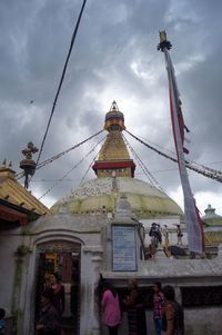 Low angle view of built structure against cloudy sky