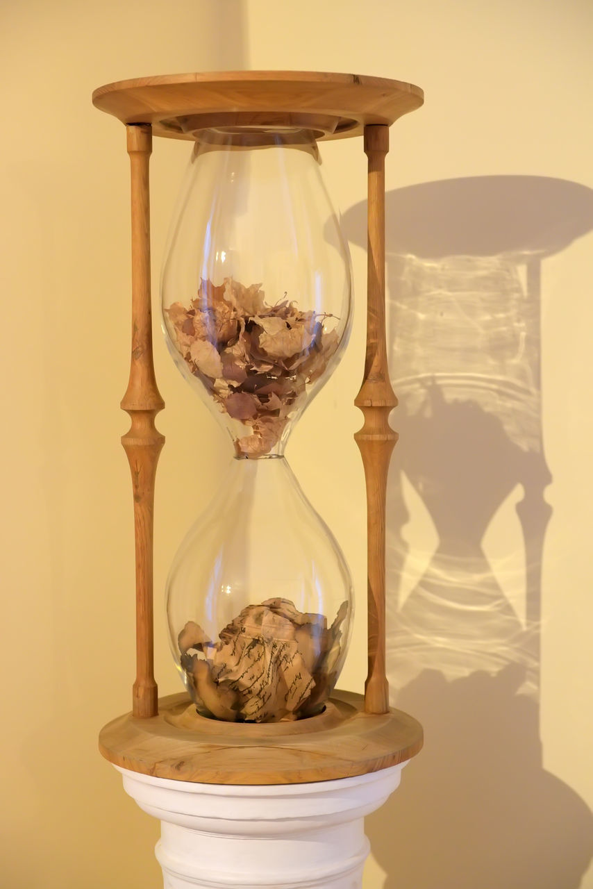 CLOSE-UP OF CLOCK ON TABLE