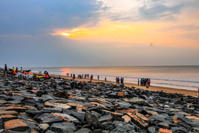 People on beach during sunset