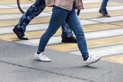 Low section of people walking on footpath