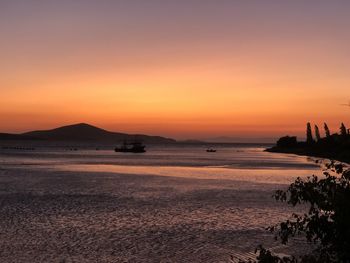 Scenic view of sea against orange sky