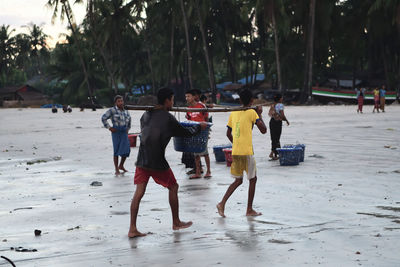 Group of people walking on beach