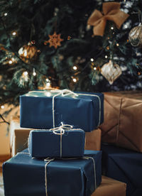 Christmas presents stacked against tree