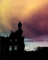 Low angle view of building against cloudy sky