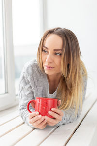 Young woman drinking coffee cup