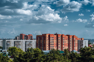 Trees and buildings against sky