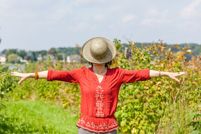 View of woman with hat standing against sky