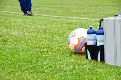 Ball and bottles on soccer field