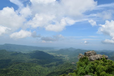 Scenic view of mountains against cloudy sky