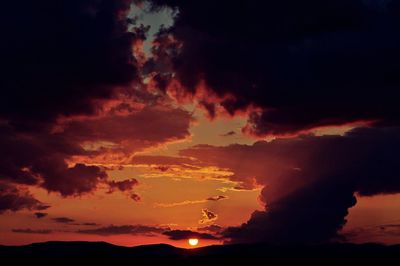 Low angle view of dramatic sky during sunset