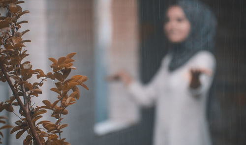 Close-up of woman standing by plants