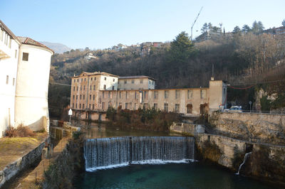 View of dam by river against sky