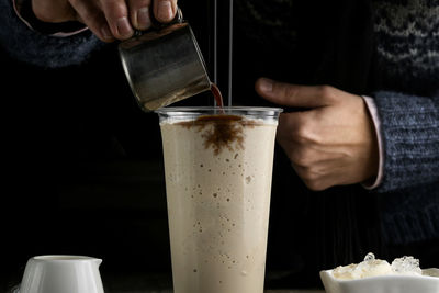 Midsection of man holding drink