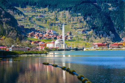 Scenic view of lake by buildings in city