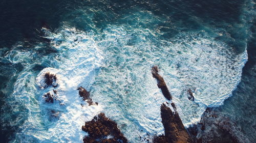 High angle view of sea by rock formation