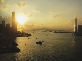 View of city at waterfront during sunset