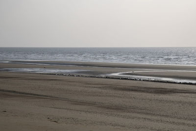 Scenic view of beach against clear sky