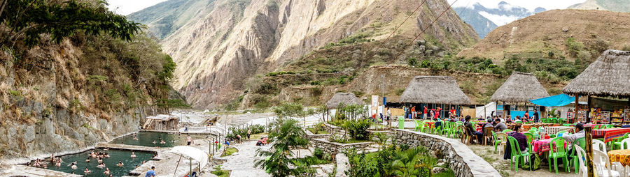 Panoramic view of trees and buildings against mountain