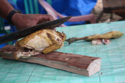 Close-up of person preparing food on cutting board