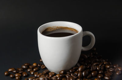 Close-up of coffee cup against black background