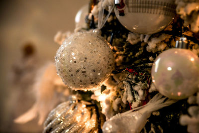 Close-up of christmas decorations hanging on tree