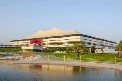 View of swimming pool by lake against clear sky