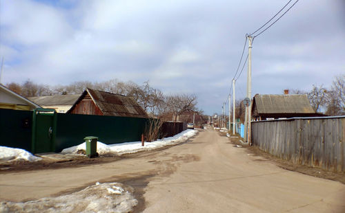 Houses by building against sky during winter