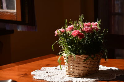 Close-up of pink flower pot on table at home