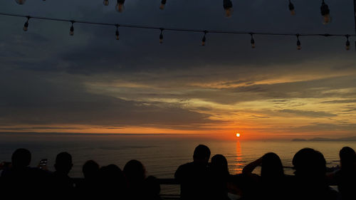 Silhouette people at sunset sky during sunrise