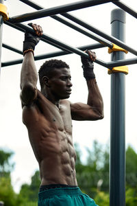 Low section of man exercising in gym