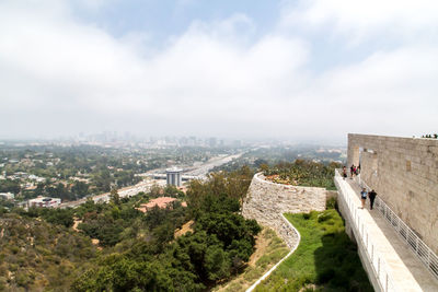 High angle view of buildings against cloudy sky