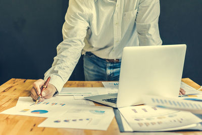 Low angle view of man working on table