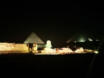 Silhouette of building against sky at night