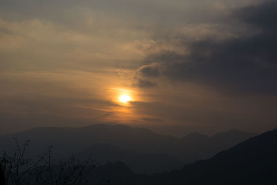 Scenic view of silhouette mountains against sky at sunset