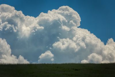 Scenic view of landscape against cloudy sky