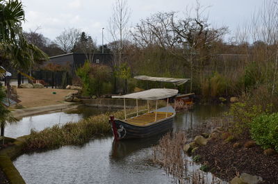 Boats moored in lake against sky