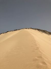 Scenic view of desert against clear sky