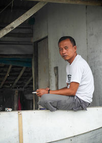 Side view of young man working at construction site