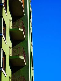Low angle view of building against clear blue sky