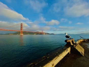 Golden gate bridge over sea against sky