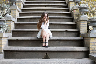 Full length portrait of woman on staircase