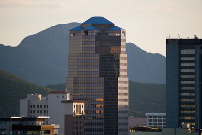 Buildings in city against sky