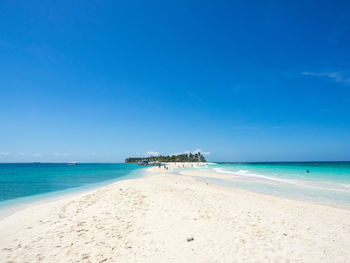 Scenic view of sea against blue sky