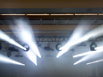 Low angle view of illuminated lighting equipment