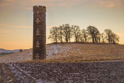 Built structure on landscape against sky