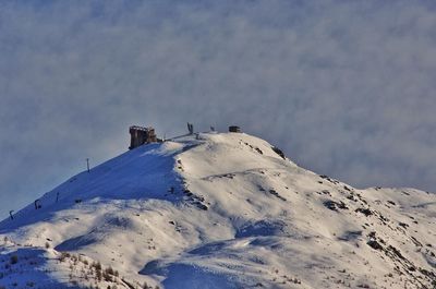 Low angle view of snowcapped mountain against sky