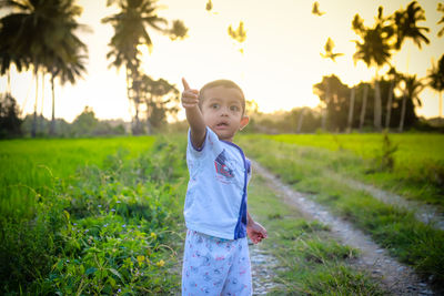 Portrait of cute girl standing on field