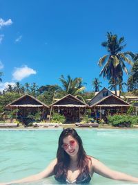 Portrait of smiling young woman in swimming pool